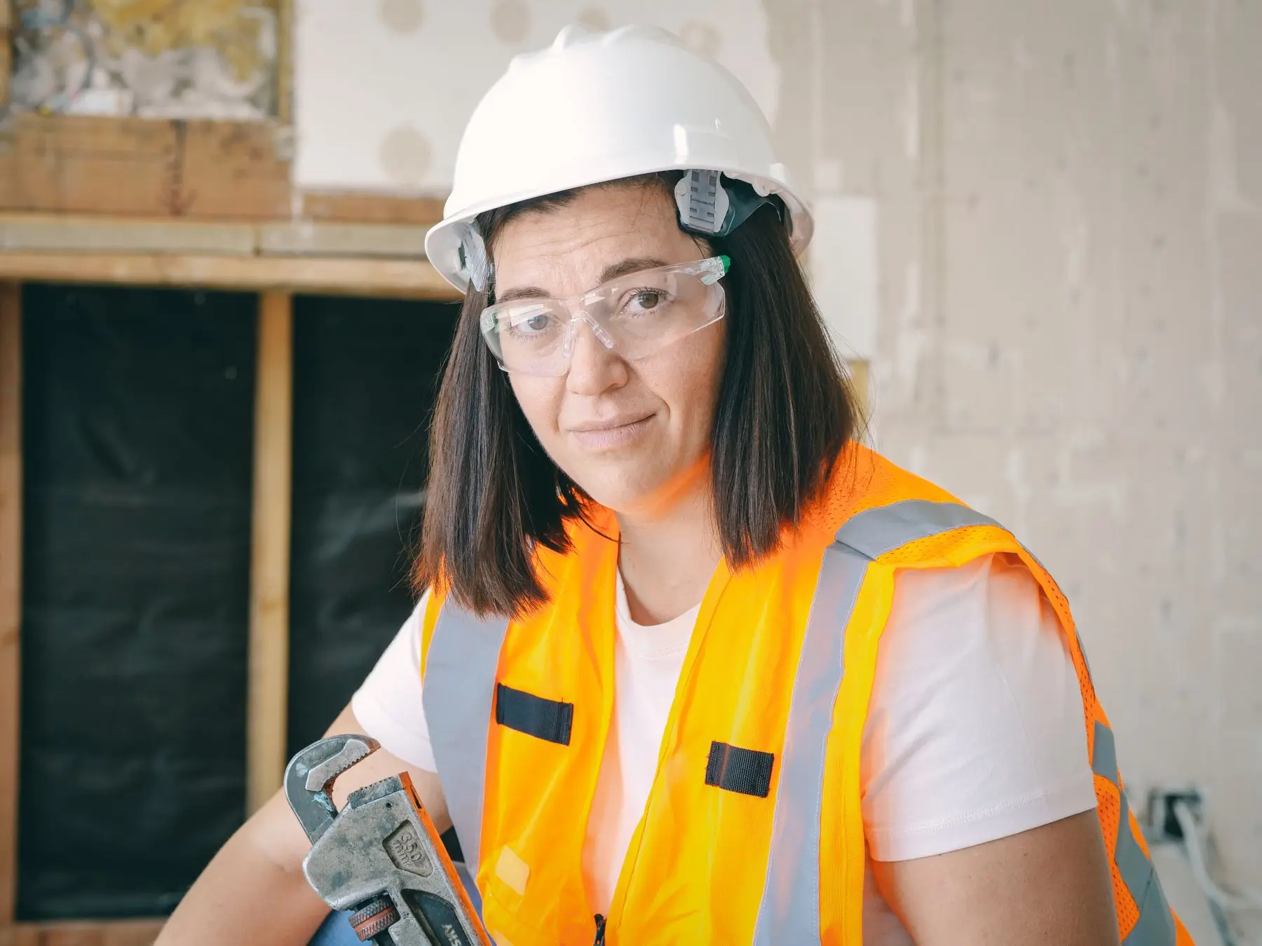 Professional tradeswoman ready for a residential service call