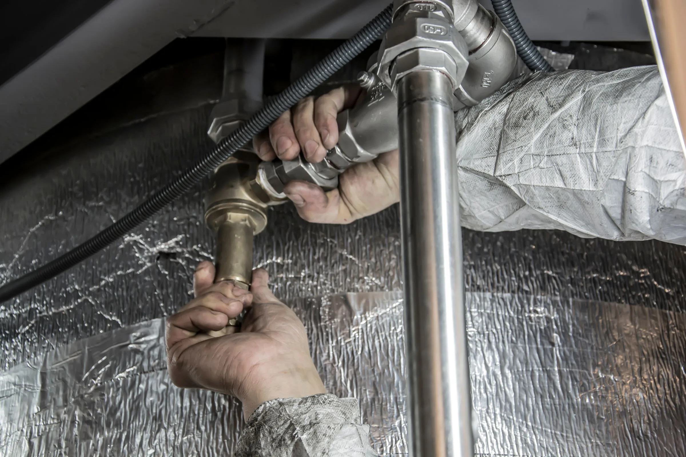 A plumber installing professional pipe fittings